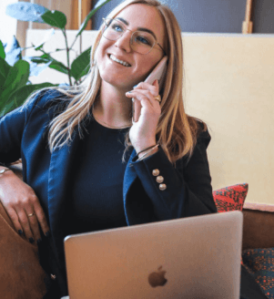 Woman talking on phone with laptop